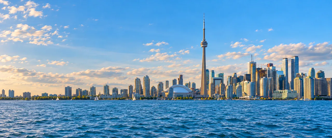 AI-generated panoramic view of Toronto's skyline and CN Tower across Lake Ontario
